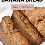 A loaf of banana bread with two slices cut from one end.