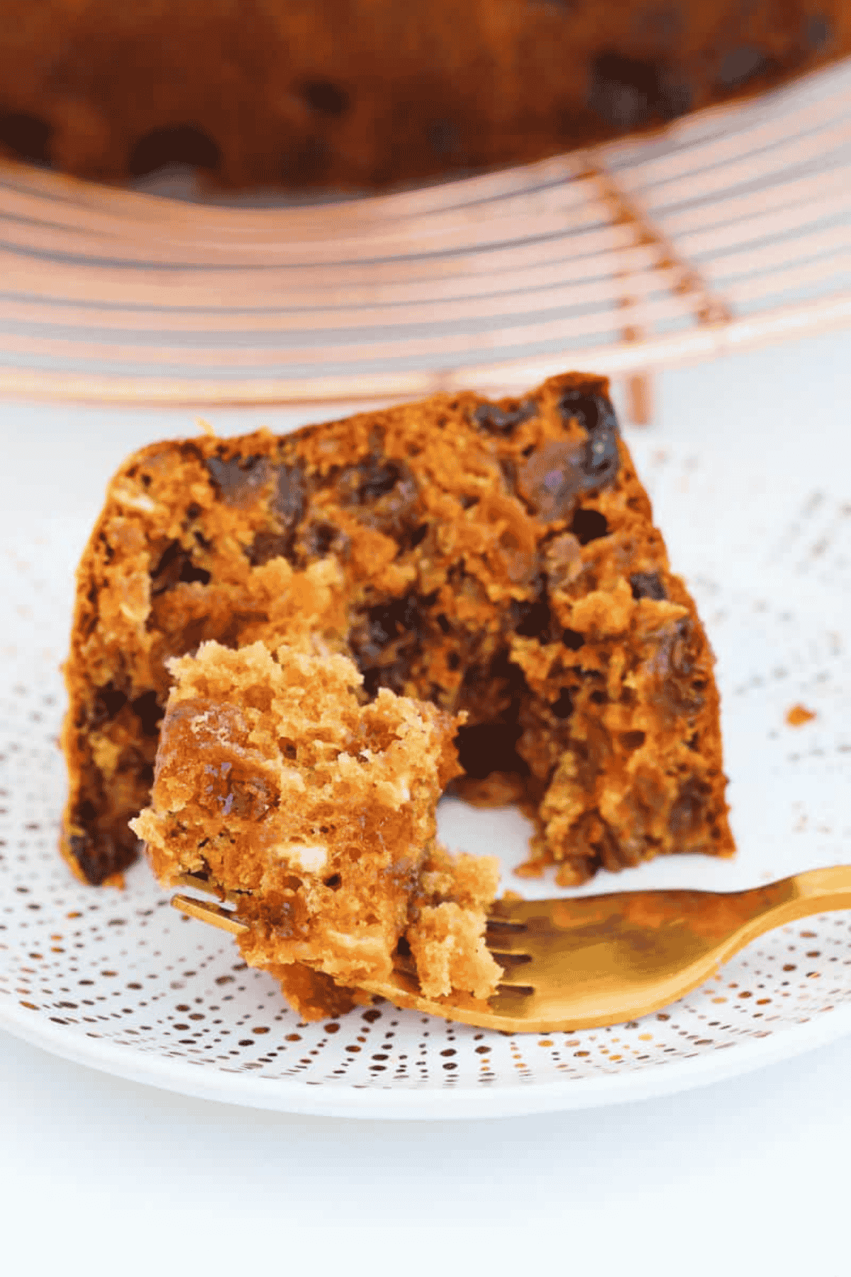 A half eaten piece of fruit cake.