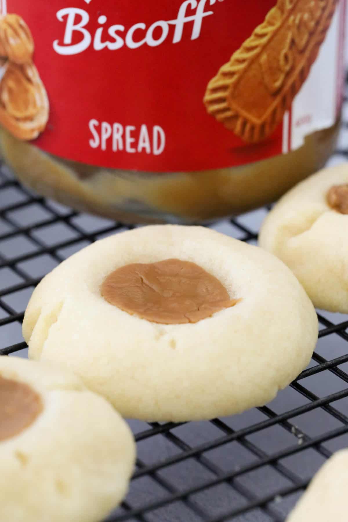 Thumbprint biscuits cooling on a wire tray.