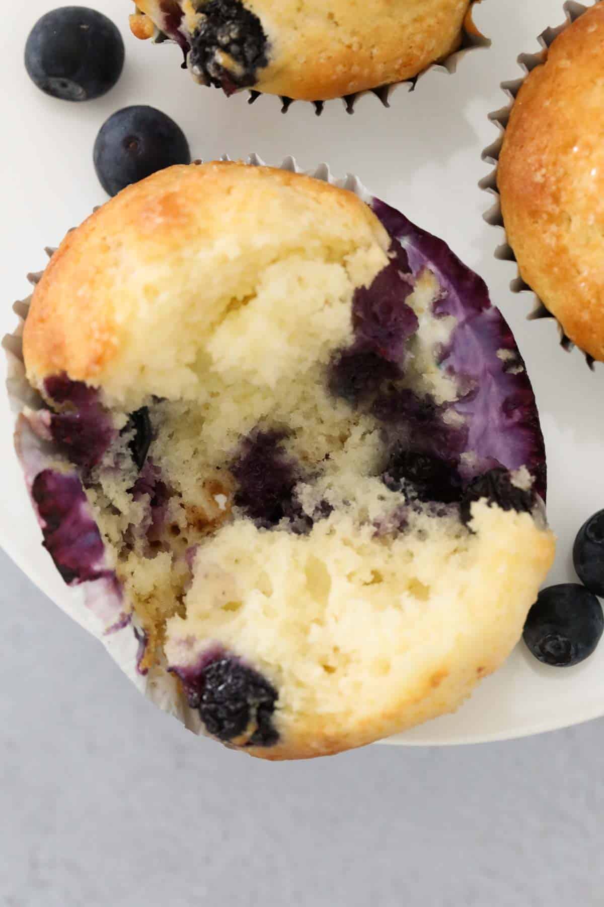 Overhead shot of a greek yoghurt muffin with blueberries throughout.