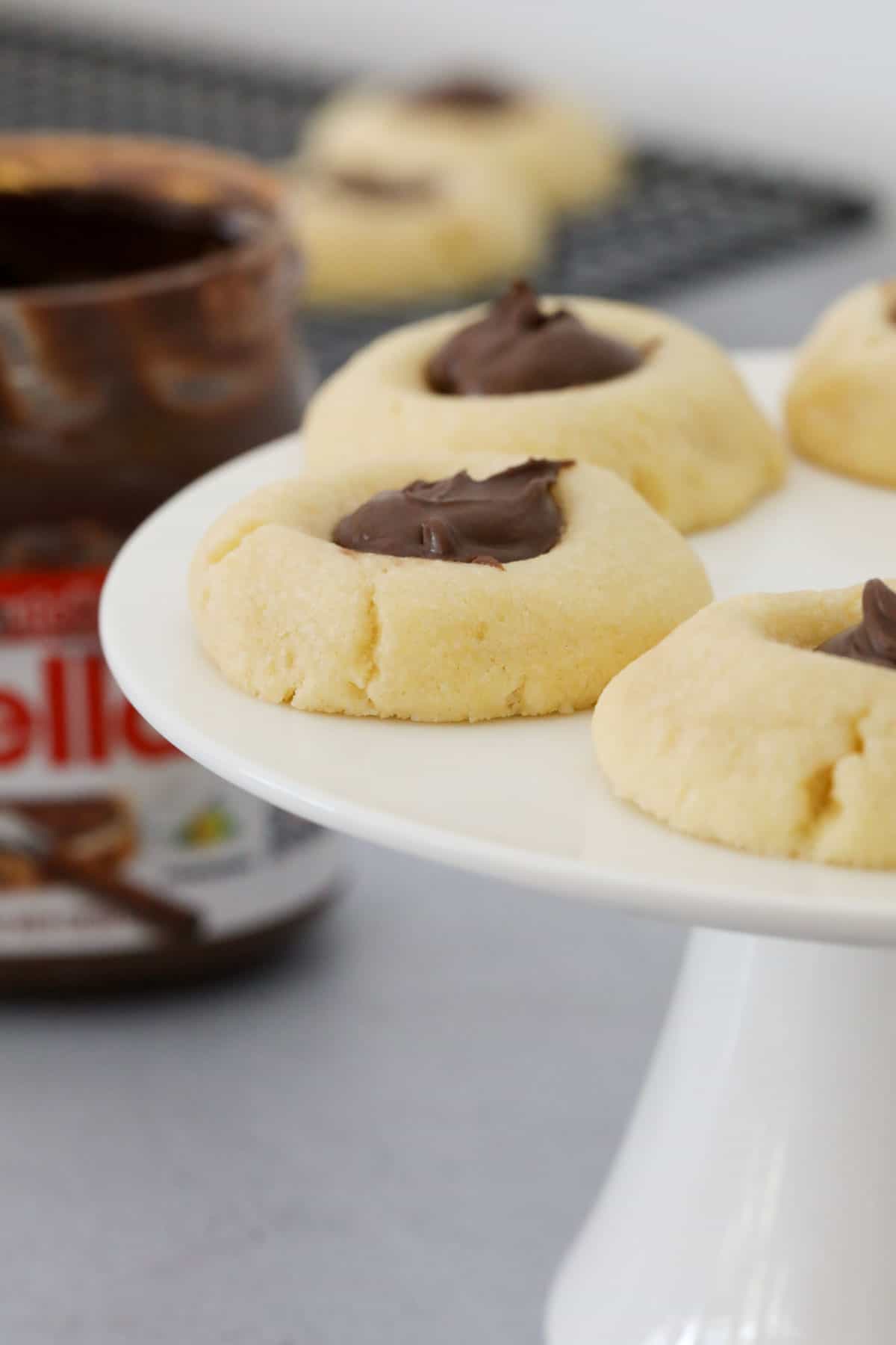 Nutella cookies served on a white cake stand.