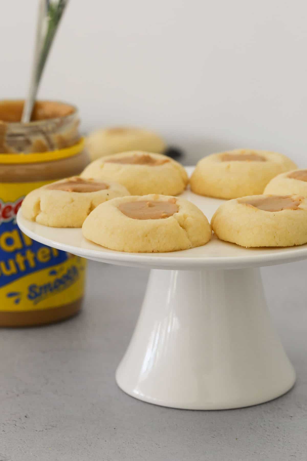 Peanut butter cookies on a white cake stand.