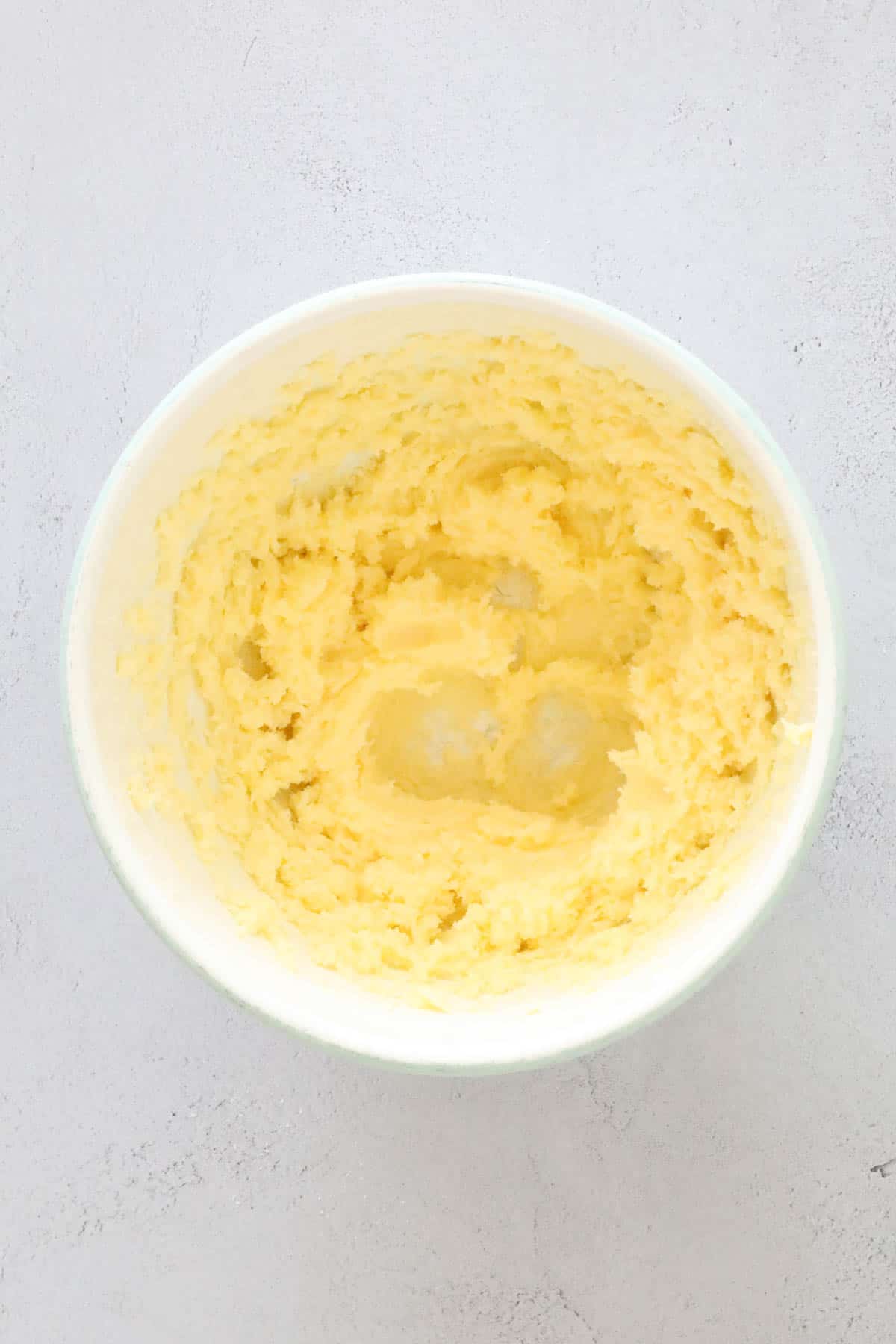 Butter and caster sugar creamed in a mixing bowl.