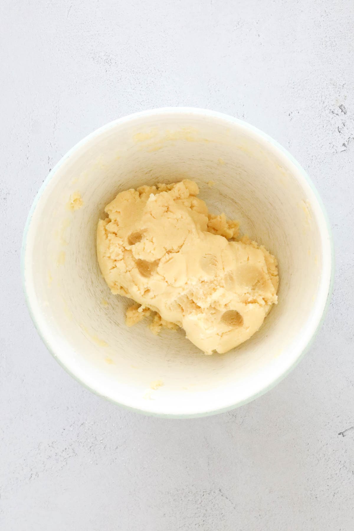 Cookie dough in a white mixing bowl.