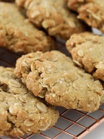 ANZAC oat biscuits cooling on a wire rack.