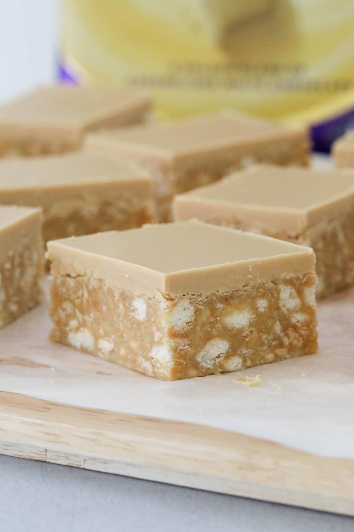Squares of caramel hedgehog slice placed on baking paper.