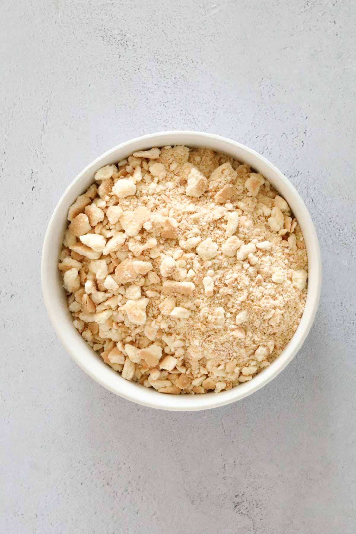 Crushed biscuit crumbs in a mixing bowl.