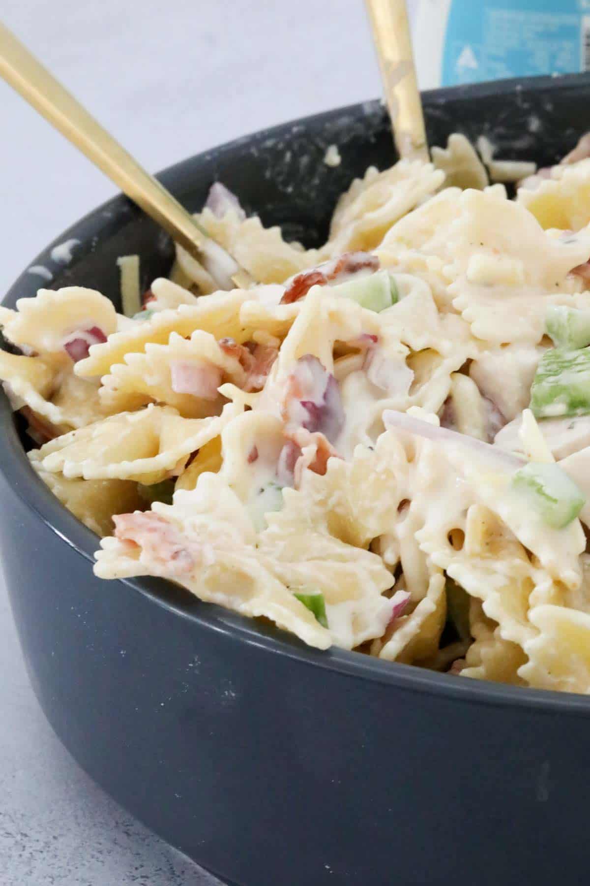 Pasta salad in a black serving bowl.