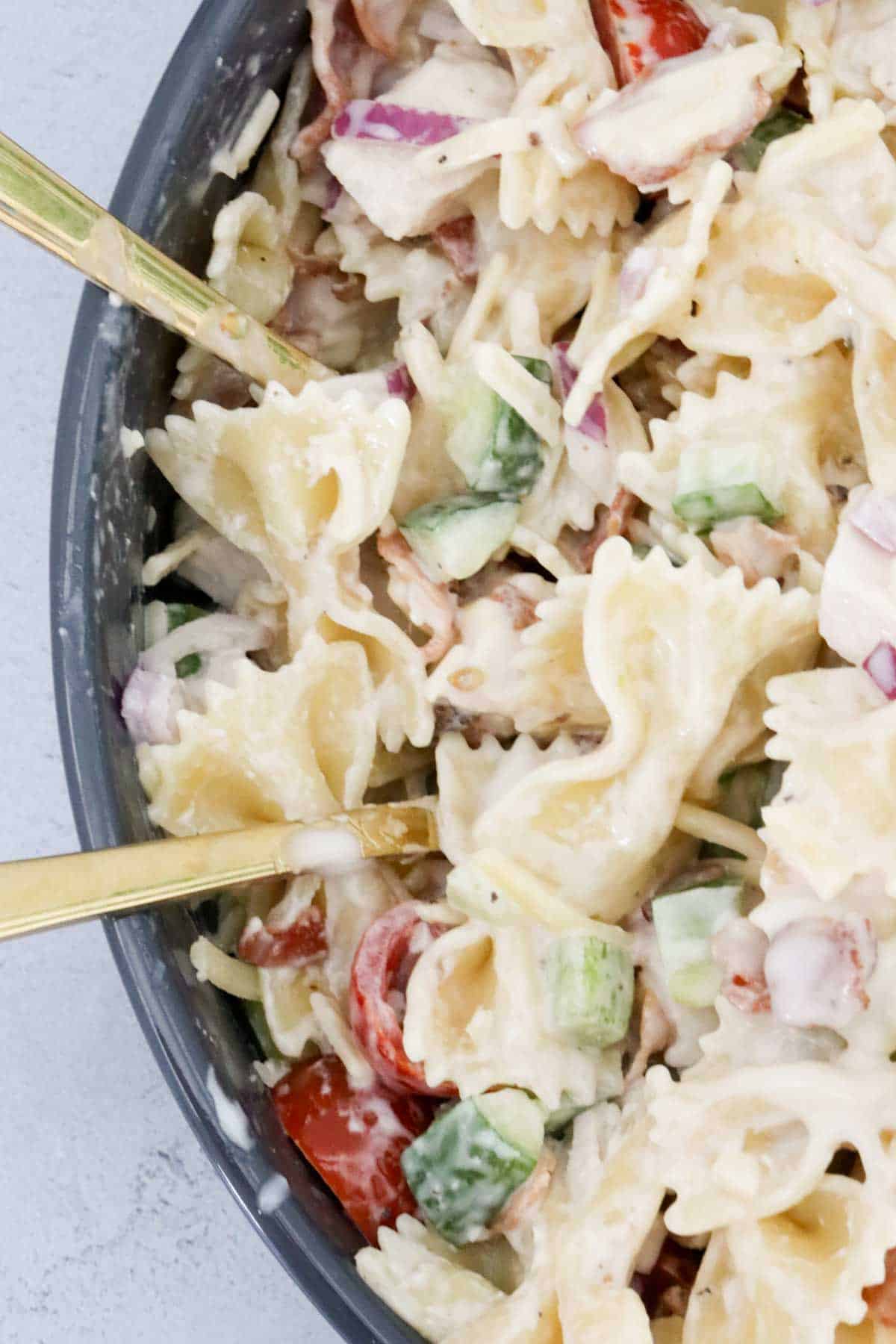 An overhead shot showing bow tie pasta in the chicken bacon salad.