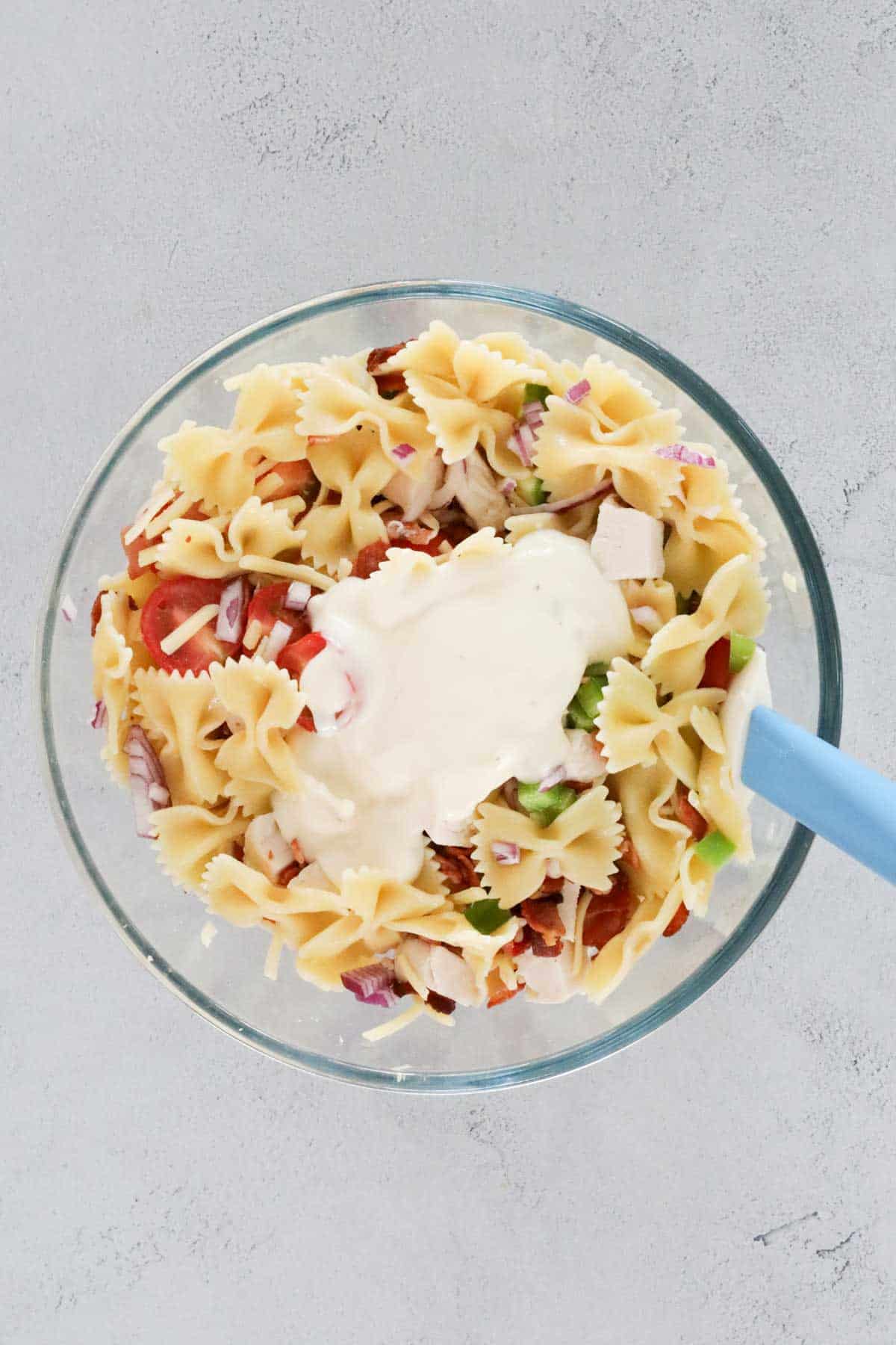 Ranch dressing added to pasta and salad ingredients.