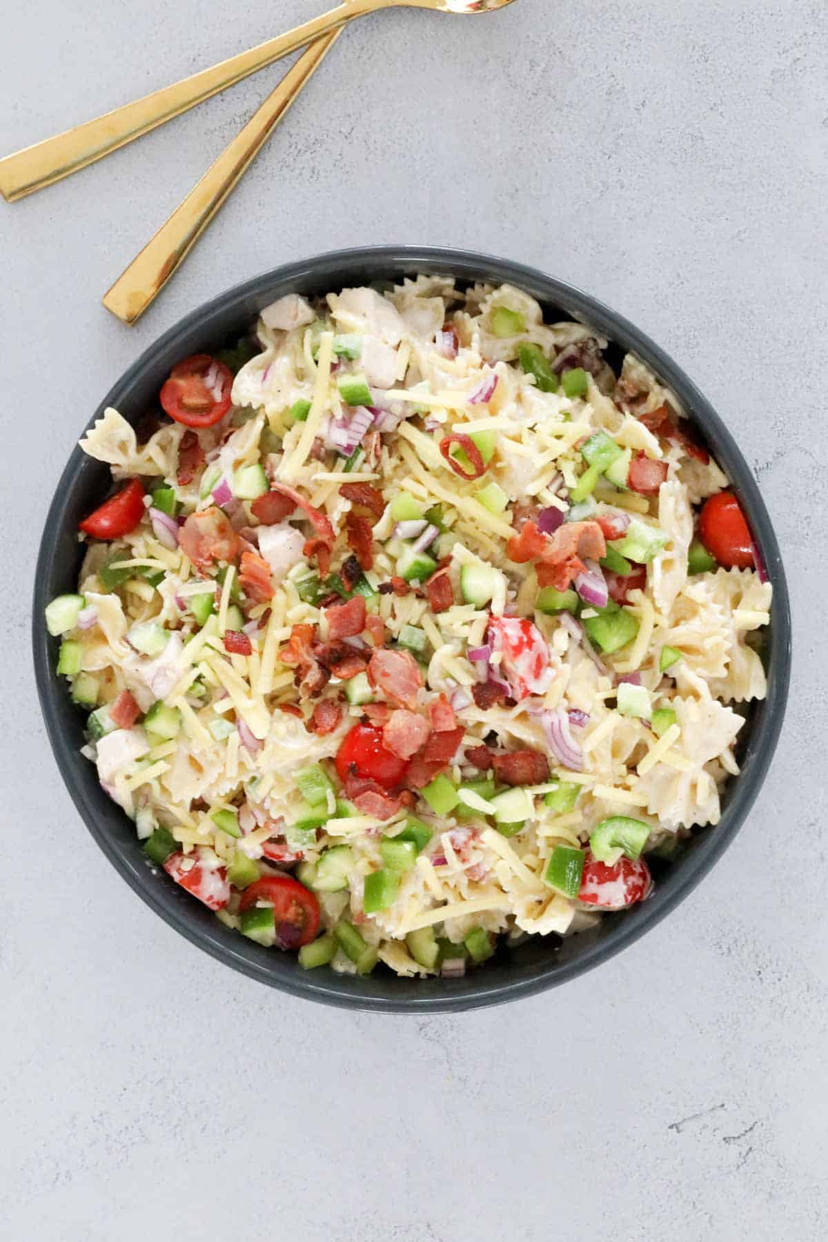 A little crispy bacon, grated cheese, chopped cherry tomatoes added on top to garnish the salad.