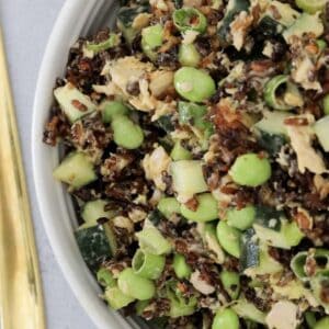 A bowl of crispy rice salad with edamame, salmon and avocado.