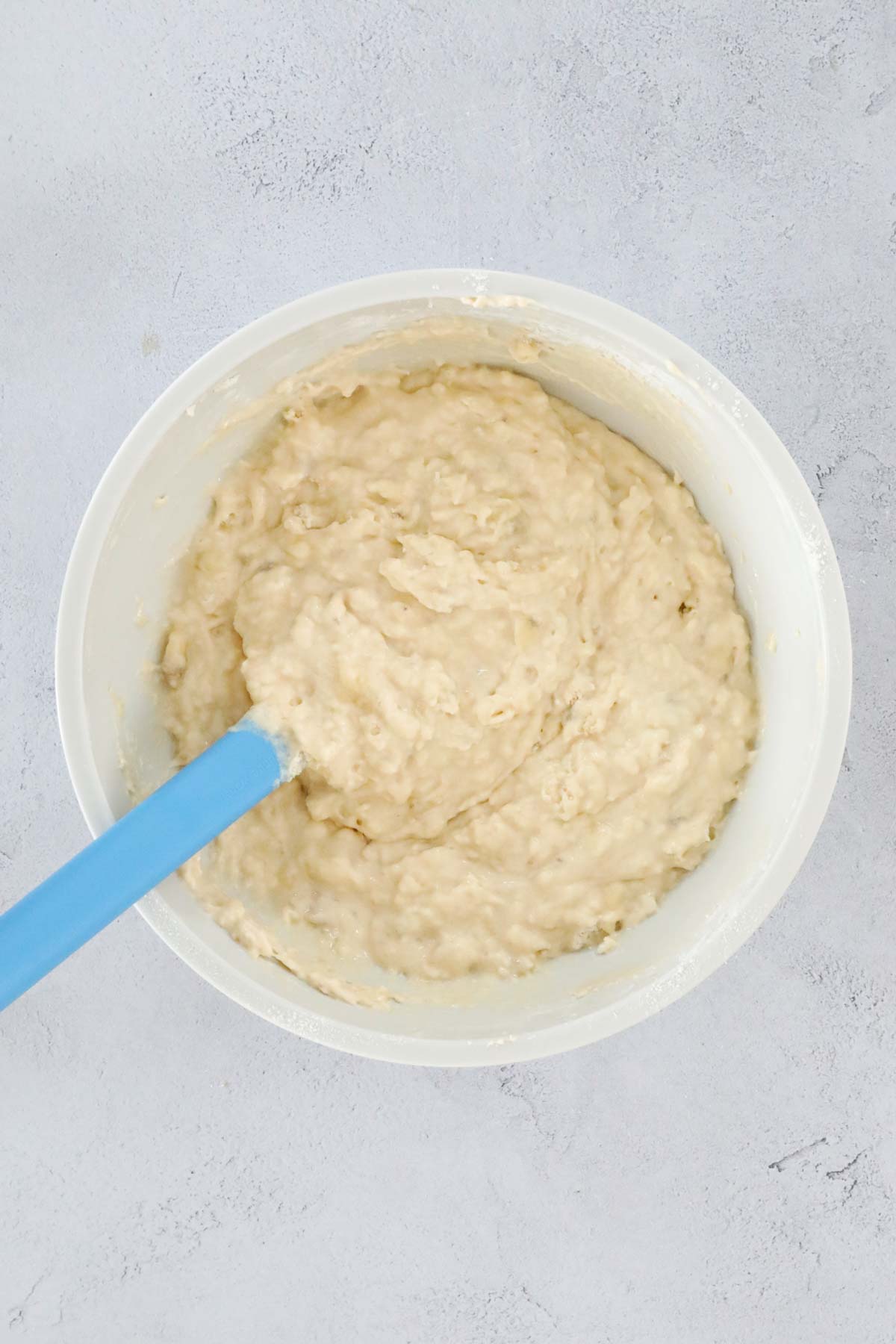 Banana greek yogurt muffin batter in a mixing bowl.