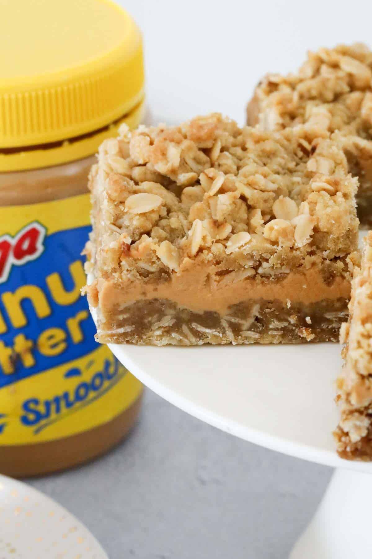 A piece of triple layered peanut butter oat bar.