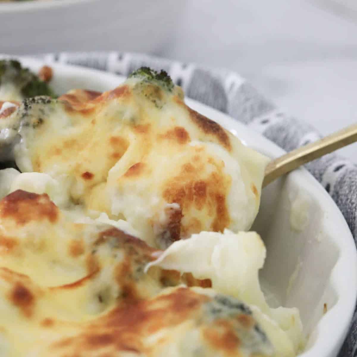 A spoonful of creamy, cheesy cauliflower and broccoli bake.