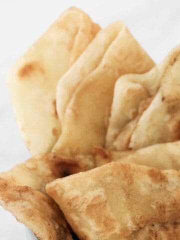 Soft homemade roti bread folded together.