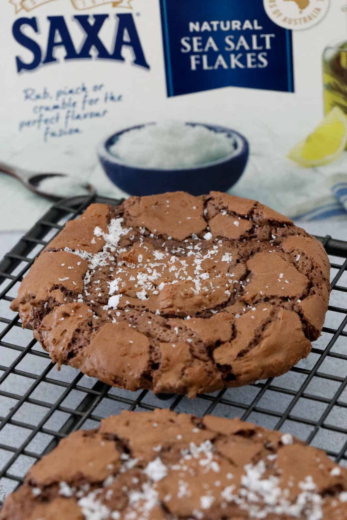Sea salt flakes sprinkled on the top of a chocolate cookie.