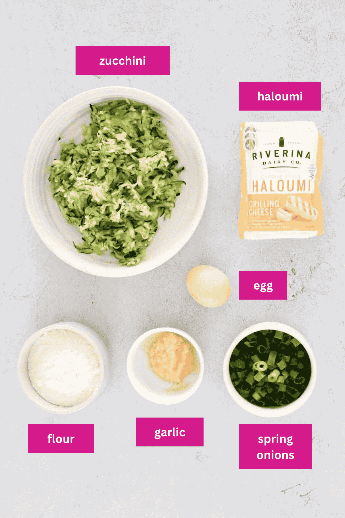 The ingredients for Halloumi and Zucchini Fritters in small bowls.